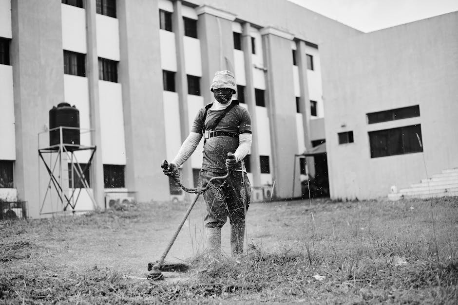 Professional landscaper performing maintenance on a vibrant garden, showcasing tools and techniques for optimal results.