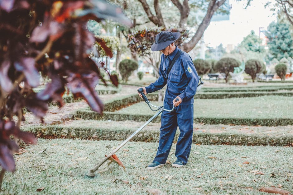 Professional landscaper at work, discussing project details with a homeowner in a vibrant garden setting.