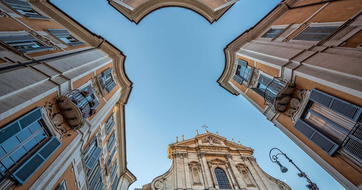 A shopper examining food labels in a grocery store aisle filled with healthy products and colorful packaging.